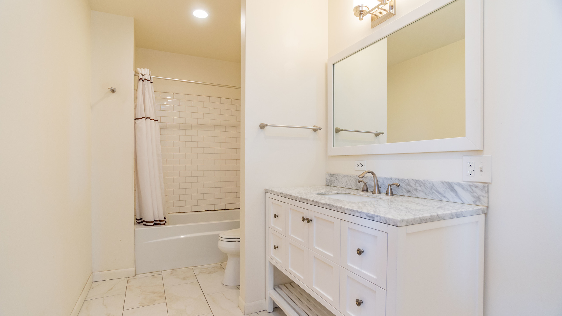 159 North Racine Avenue, Unit 2W Chicago, IL 60607 - Photo 10 of 11 a bathroom with a granite countertop sink toilet and shower