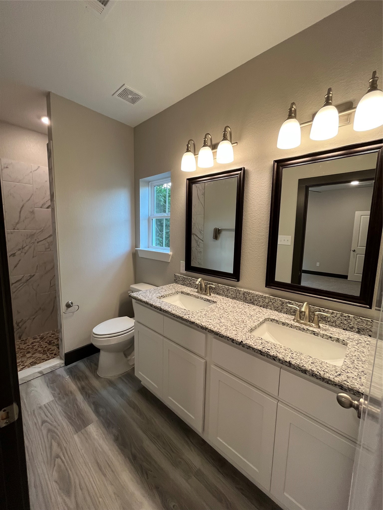 111 Heatherbrook Somerville, TX 77879 - Photo 8 of 11 a bathroom with double sink and a mirror