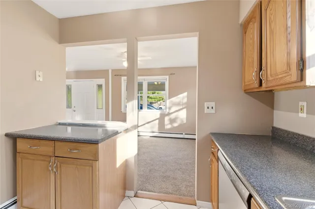 a kitchen with granite countertop a sink and a refrigerator