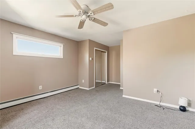 a view of an empty room and a ceiling fan