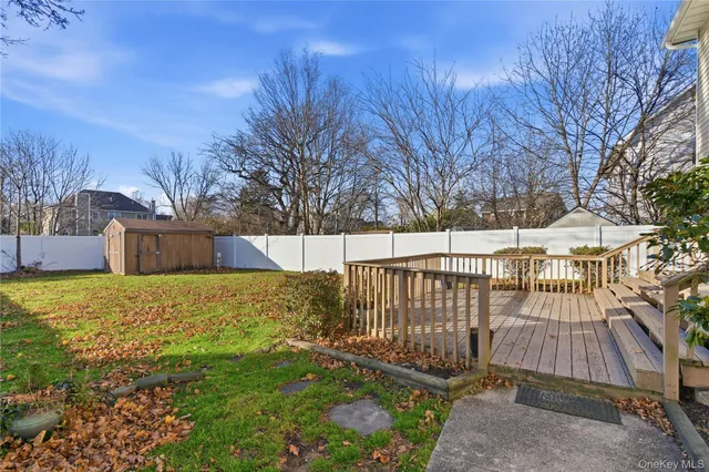 a view of backyard with wooden fence