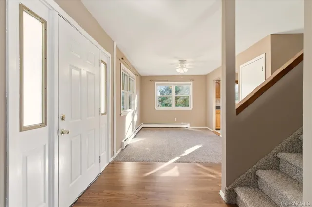 a view of a hallway with windows and entryway