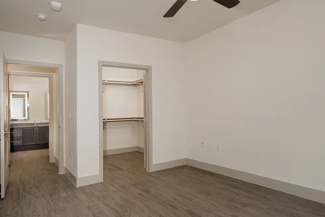 a view of an empty room with closet and a window