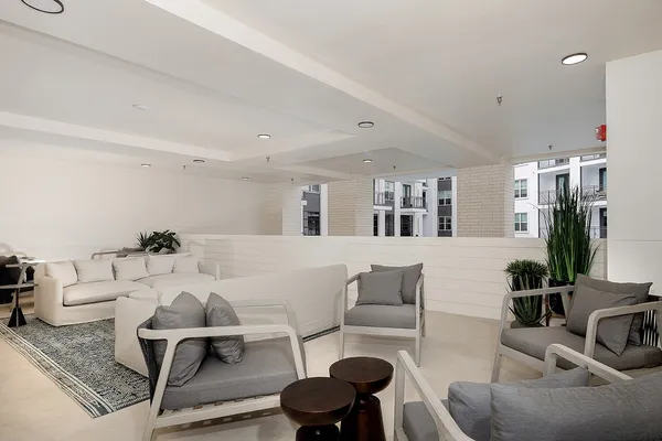 a living room with furniture and view of kitchen