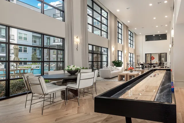 a living room with furniture and large windows