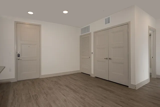 a view of an empty room with wooden floor