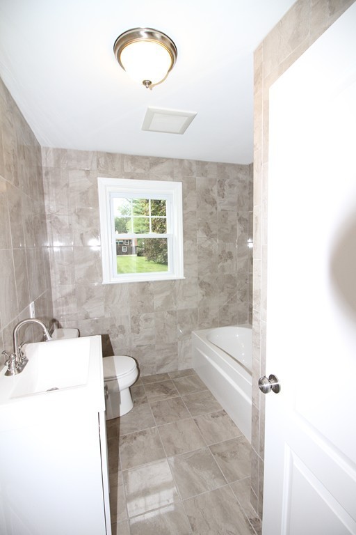 68 Mill Road East Longmeadow, MA 01028 - Photo 6 of 12 a bathroom with a sink a toilet a mirror and window