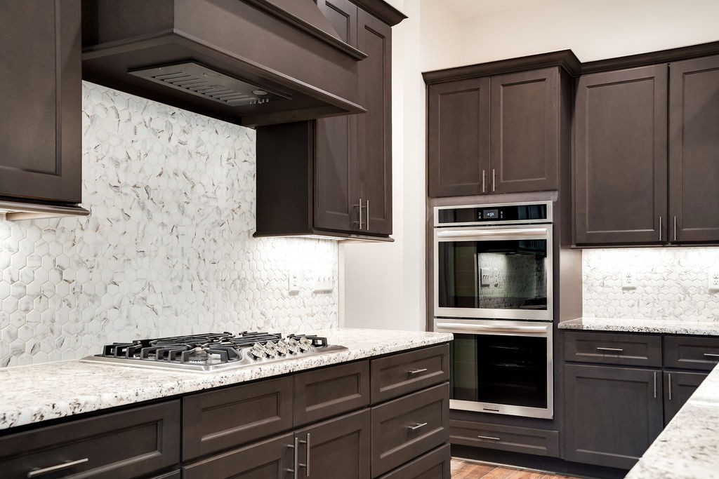 685 Wallace Road Gallatin, TN 37066 - Photo 30 of 64 a kitchen with granite countertop cabinets stainless steel appliances and wooden floor