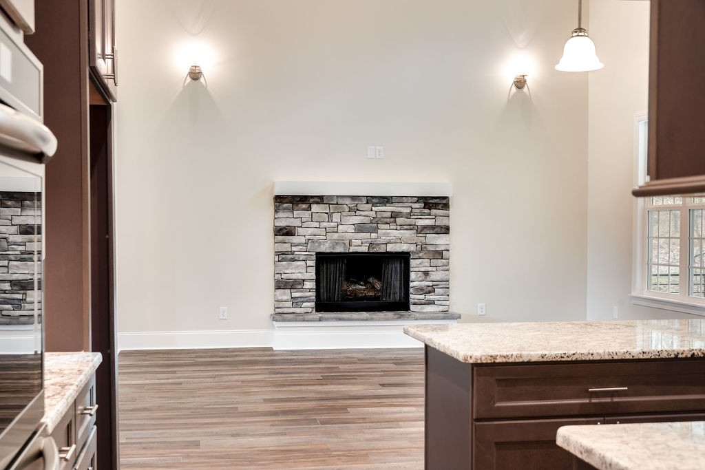 685 Wallace Road Gallatin, TN 37066 - Photo 31 of 64 a living room with granite countertop furniture a fireplace and a flat screen tv