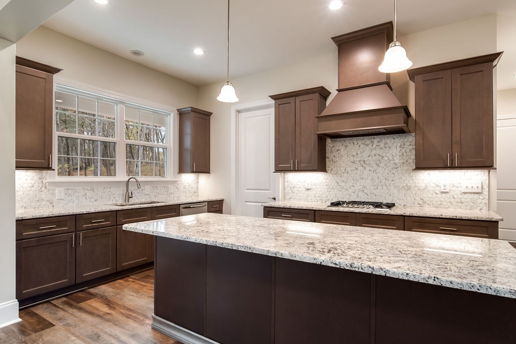685 Wallace Road Gallatin, TN 37066 - Photo 39 of 64 a kitchen with stainless steel appliances granite countertop a sink a stove and a wooden cabinets