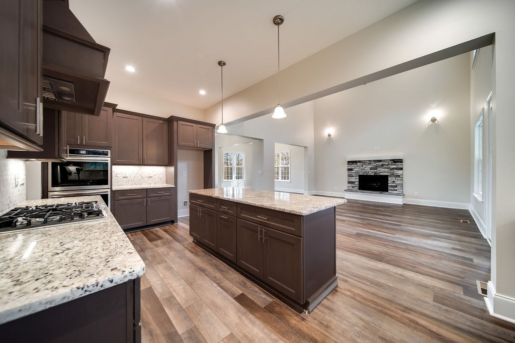 685 Wallace Road Gallatin, TN 37066 - Photo 41 of 64 a large kitchen with stainless steel appliances kitchen island granite countertop a stove and a sink