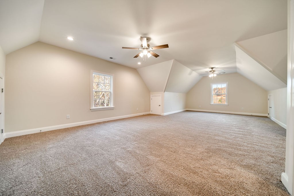 685 Wallace Road Gallatin, TN 37066 - Photo 60 of 64 an empty room with a chandelier fan and windows
