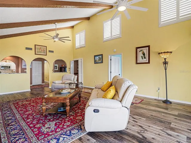 a living room with couches and painting on the wall