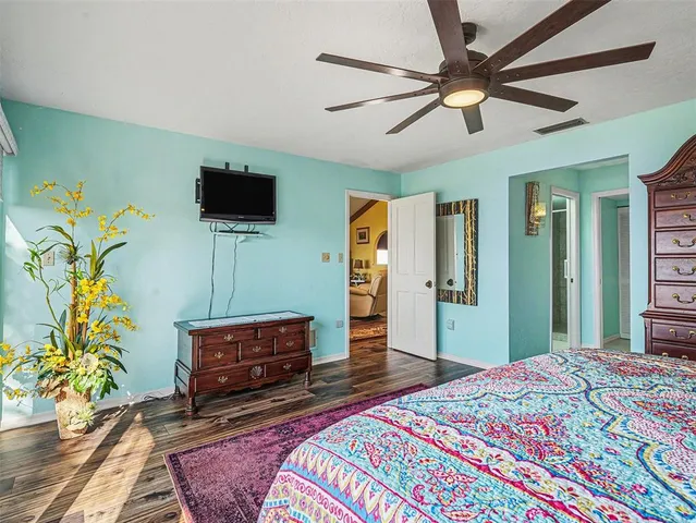 a bedroom with a bed and a television