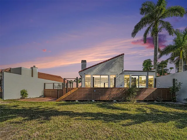 a front view of a house with a garden and yard