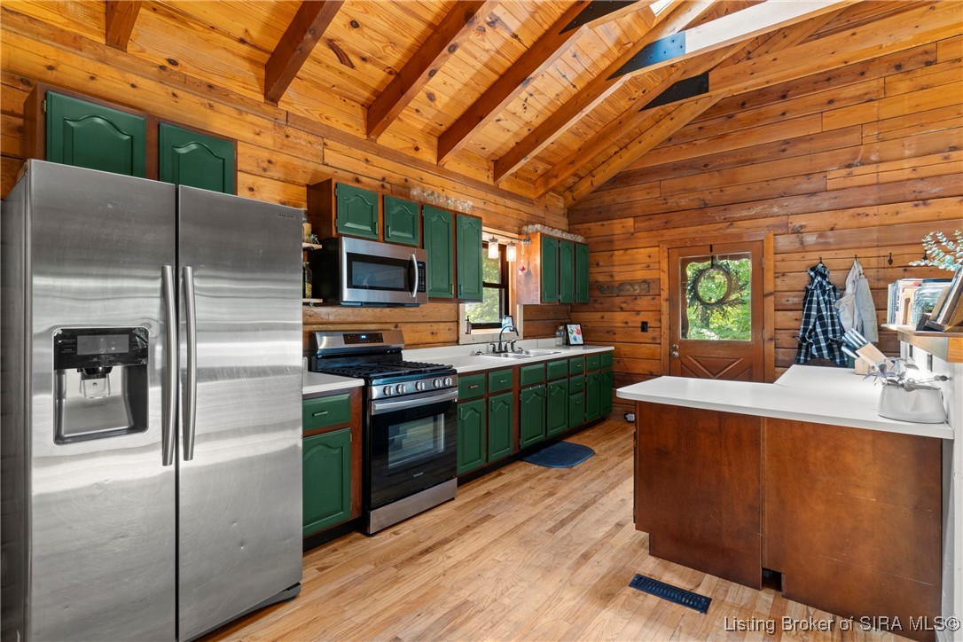 3895 Utz Road Northeast Georgetown, IN 47122 - Photo 11 of 70 Spacious kitchen with vaulted wood ceilings, green cabinetry, and stainless steel appliances.