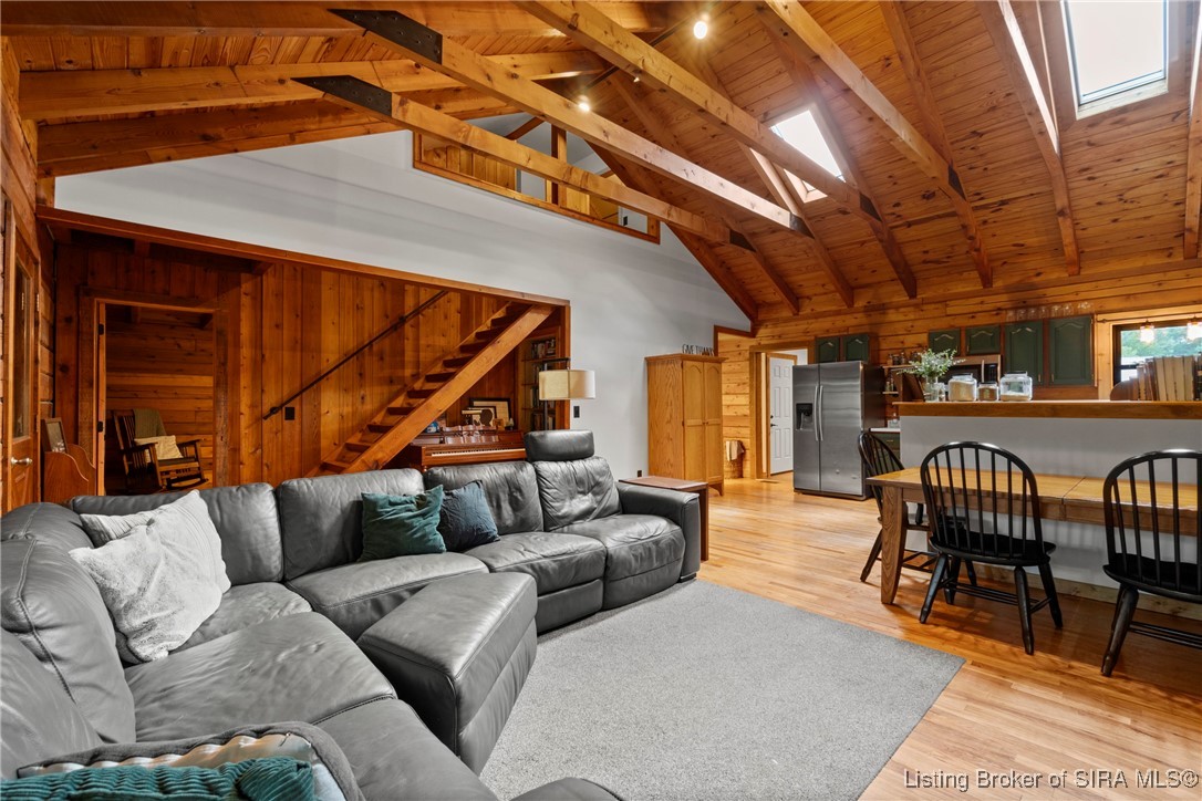 3895 Utz Road Northeast Georgetown, IN 47122 - Photo 14 of 70 Open living area showcasing vaulted ceilings, skylights, and a view into the kitchen and dining space.