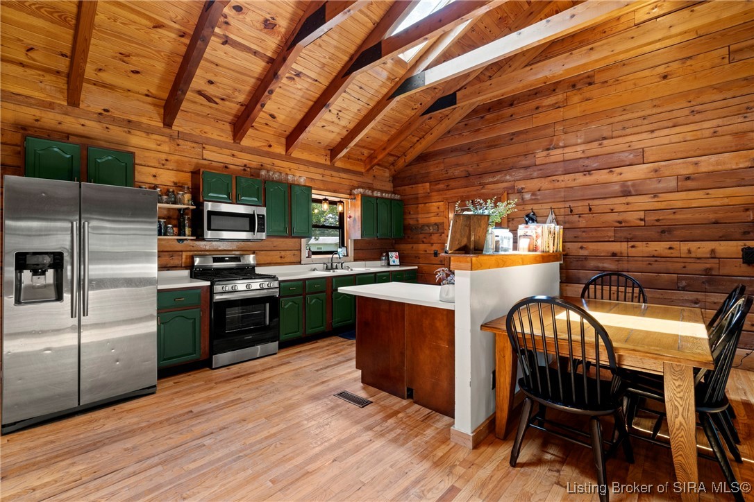 3895 Utz Road Northeast Georgetown, IN 47122 - Photo 15 of 70 Kitchen and dining area with natural wood walls and floors.