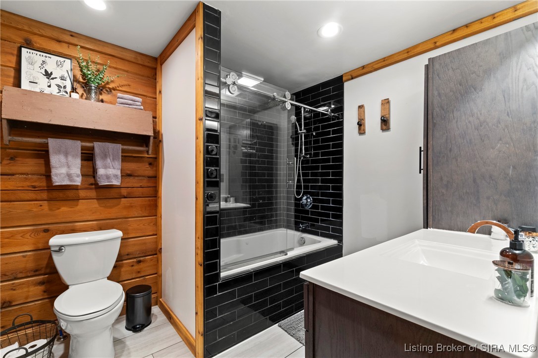 3895 Utz Road Northeast Georgetown, IN 47122 - Photo 21 of 70 Primary Bathroom – Blends rustic charm with modern finishes, including a jetted tub/shower combo with black tile surround and rainfall showerhead.