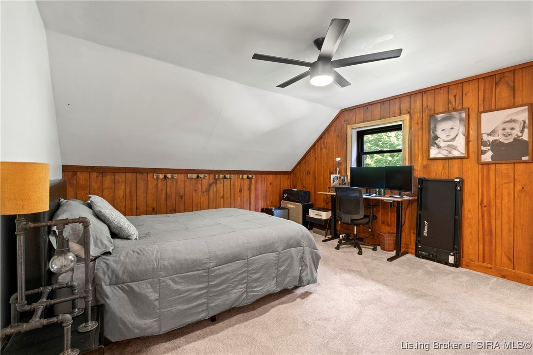 3895 Utz Road Northeast Georgetown, IN 47122 - Photo 24 of 70 Upstairs Bedroom – Wood accent walls, neutral carpeting, and a large window create a bright and versatile space.