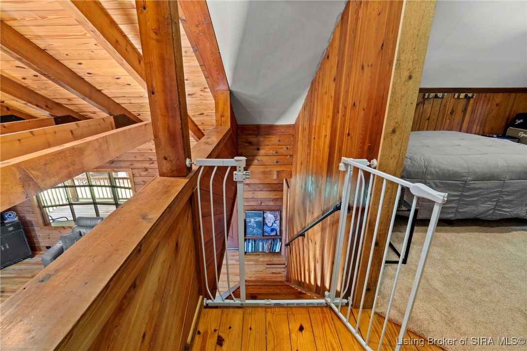 3895 Utz Road Northeast Georgetown, IN 47122 - Photo 28 of 70 Loft Staircase View – Overlooks the living area with exposed beams, leading up to the second-floor bedrooms.