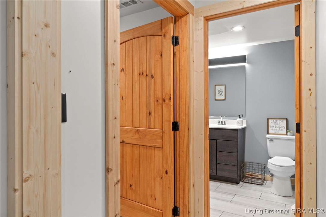 3895 Utz Road Northeast Georgetown, IN 47122 - Photo 37 of 70 Lower-Level Full Bathroom – Modern design with gray walls, dark vanity, and tile flooring.