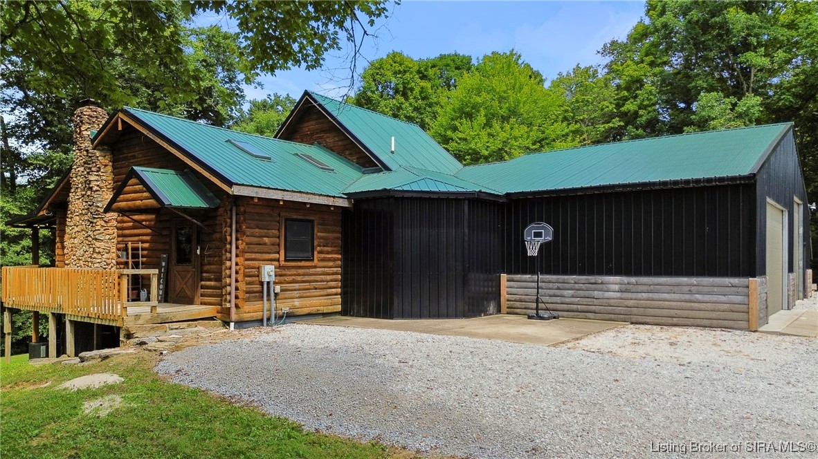 3895 Utz Road Northeast Georgetown, IN 47122 - Photo 43 of 70 Alternate Front Exterior View – Highlights wrap-around driveway and wooded surroundings.