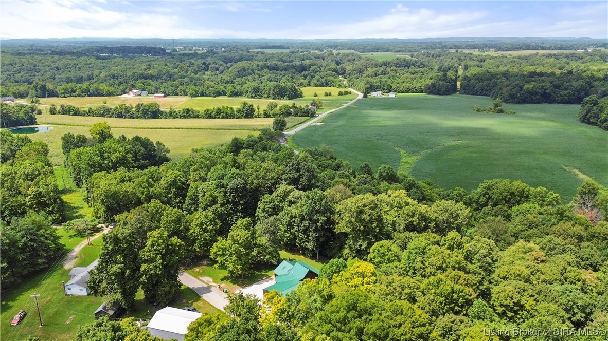 3895 Utz Road Northeast Georgetown, IN 47122 - Photo 46 of 70 Aerial View Over Surrounding Farmland – Sweeping view of lush fields, wooded areas, and the quiet country road leading to the property.