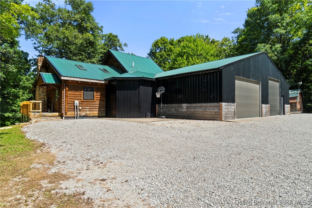 3895 Utz Road Northeast Georgetown, IN 47122 - Photo 52 of 70 Front Drive and Garage View – Gravel driveway leading to attached oversized garage and workshop with dual garage doors.