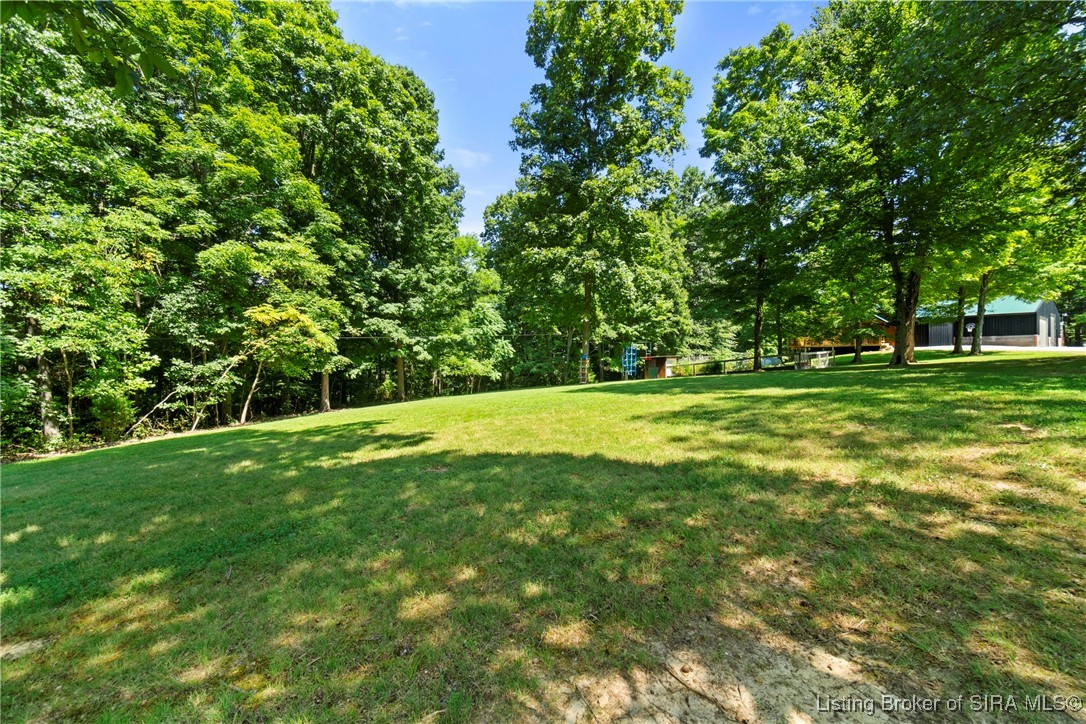 3895 Utz Road Northeast Georgetown, IN 47122 - Photo 60 of 70 Open Yard with Mature Trees – Wide lawn framed by tall trees offering both shade and open space.