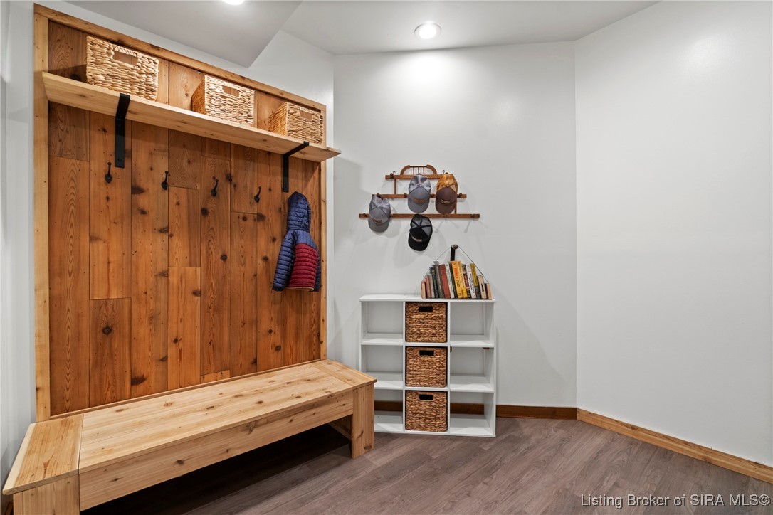 3895 Utz Road Northeast Georgetown, IN 47122 - Photo 65 of 70 Mudroom with wooden bench, coat hooks, storage cubbies, and shelving for hats and books.