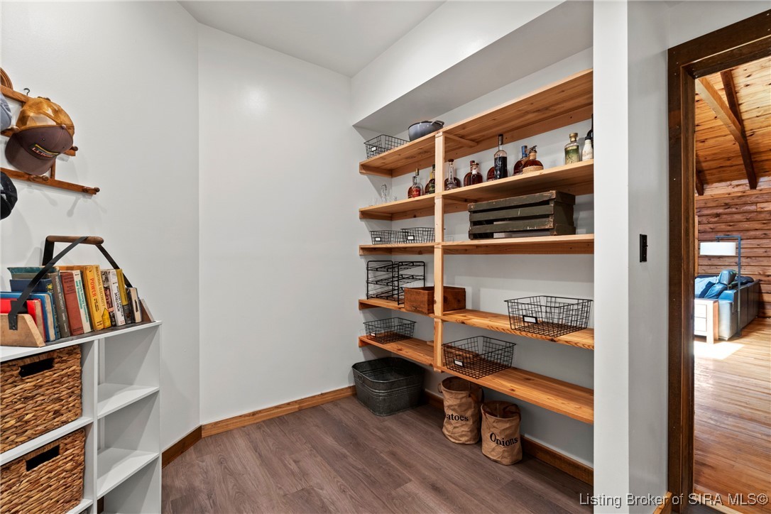 3895 Utz Road Northeast Georgetown, IN 47122 - Photo 66 of 70 Walk-in pantry with natural wood shelving, wire baskets, and space for bulk storage.