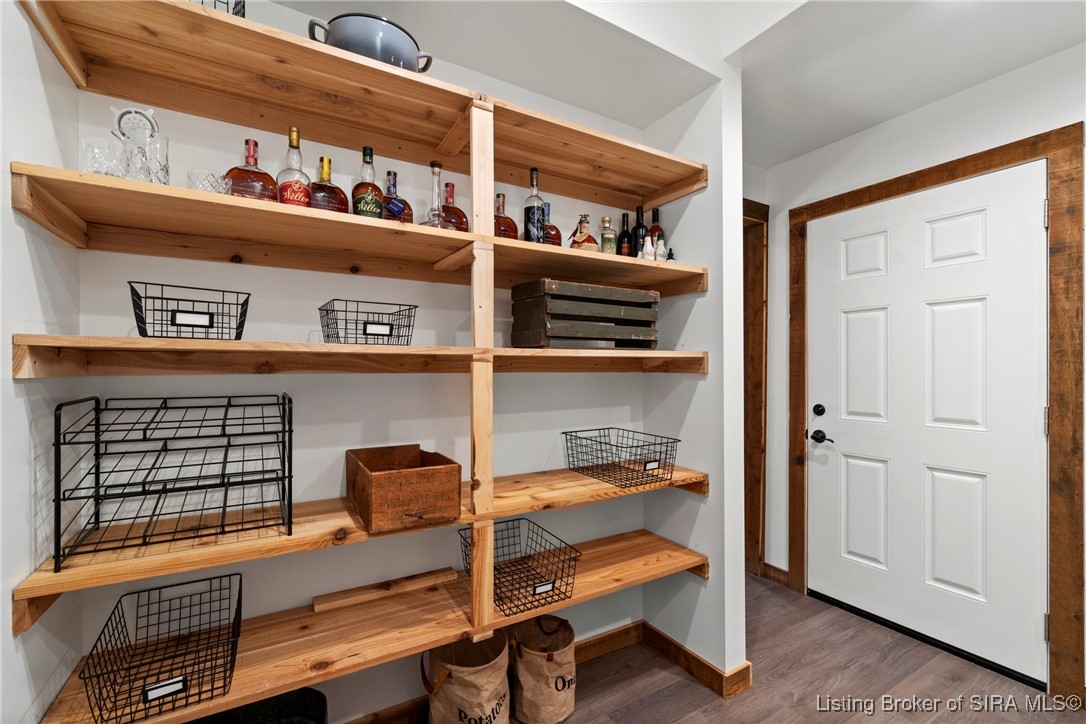 3895 Utz Road Northeast Georgetown, IN 47122 - Photo 67 of 70 Walk-in pantry with open wood shelving, wire baskets, and ample storage space, conveniently located off the kitchen.