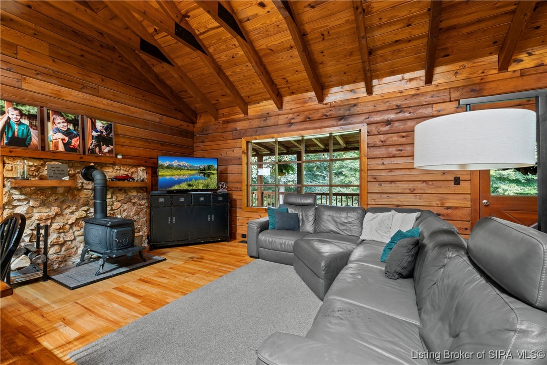 3895 Utz Road Northeast Georgetown, IN 47122 - Photo 68 of 70 Living room with sectional sofa and stone fireplace with wood-burning stove.