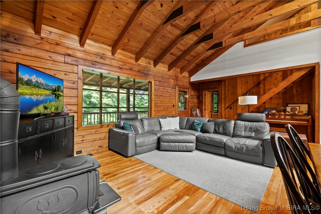 3895 Utz Road Northeast Georgetown, IN 47122 - Photo 7 of 70 Cozy living room with vaulted wood-beamed ceiling, leather sectional sofa, and large picture window.