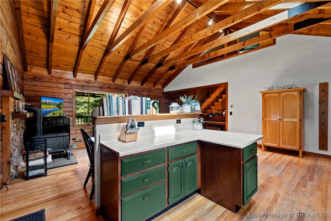 3895 Utz Road Northeast Georgetown, IN 47122 - Photo 10 of 70 Kitchen island with breakfast bar and built-in shelving overlooking the living space.