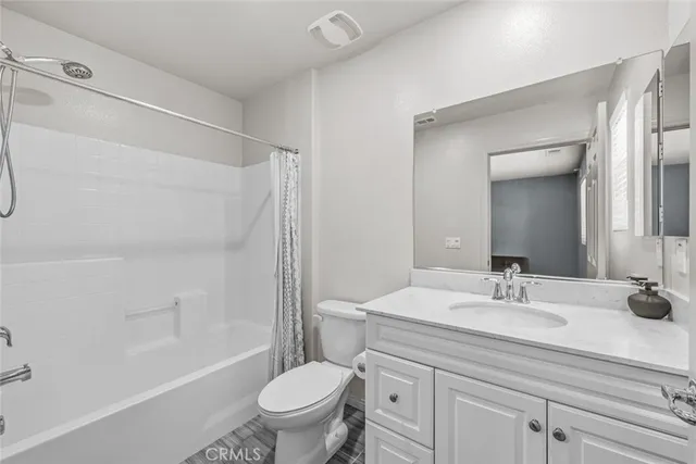 a bathroom with a sink toilet vanity and shower