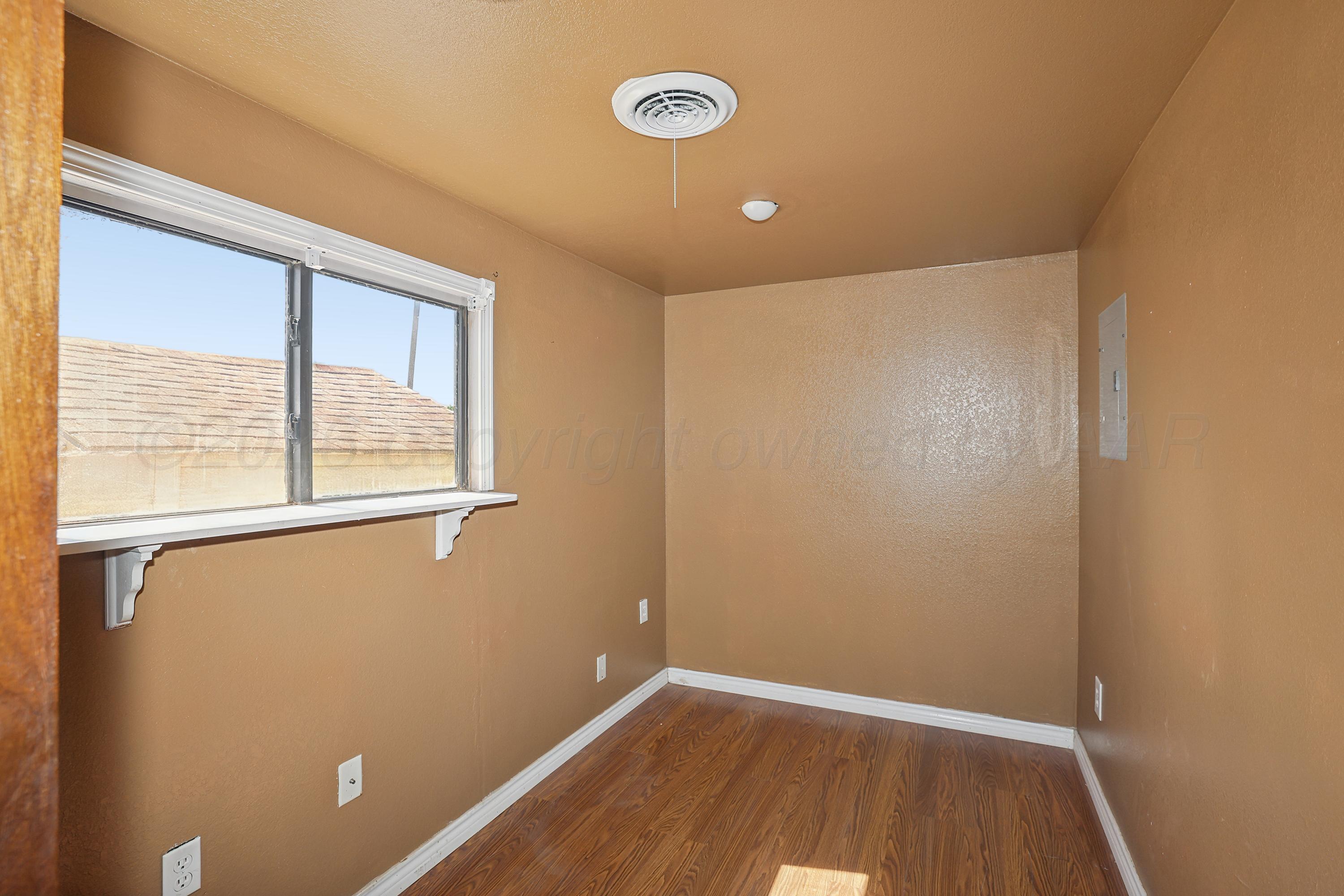 14200 Savannah Road Amarillo, TX 79118 - Photo 23 of 34 a view of an empty room with wooden floor and a window