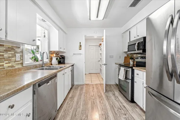 a kitchen with wooden cabinets and stainless steel appliances