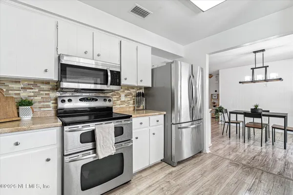a kitchen with sink and cabinets