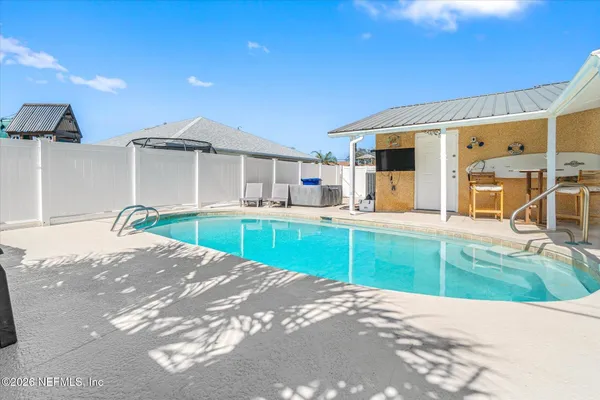 a view of a house with swimming pool and sitting area