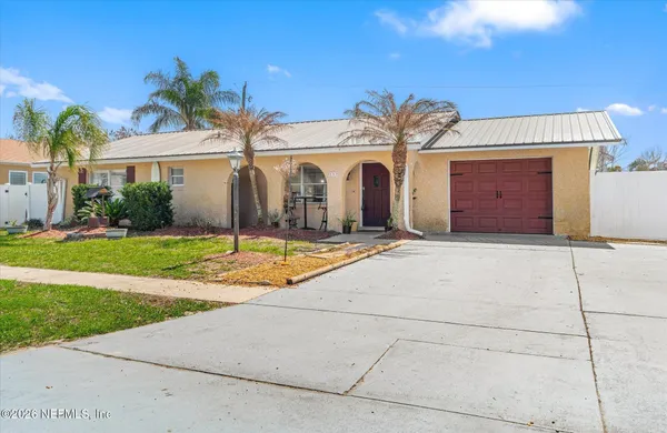 a front view of a house with yard and garage