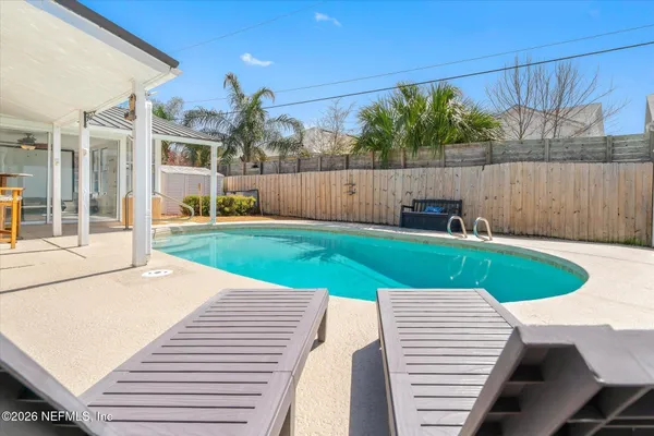 a view of swimming pool with a yard