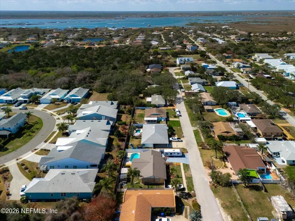 an aerial view of residential houses with city view