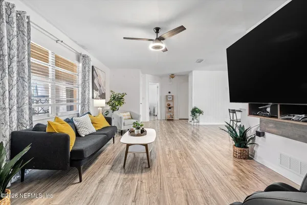 a living room with furniture and a flat screen tv