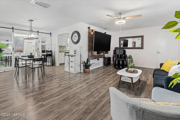 a view of a dining room with furniture and wooden floor
