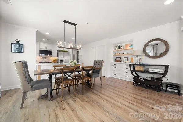 a living room with furniture windows and a wooden floor