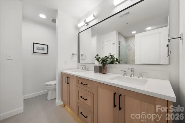 a bathroom with a sink double vanity and a mirror