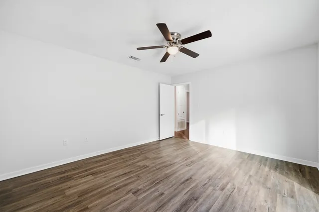 a view of a big room with wooden floor and closet