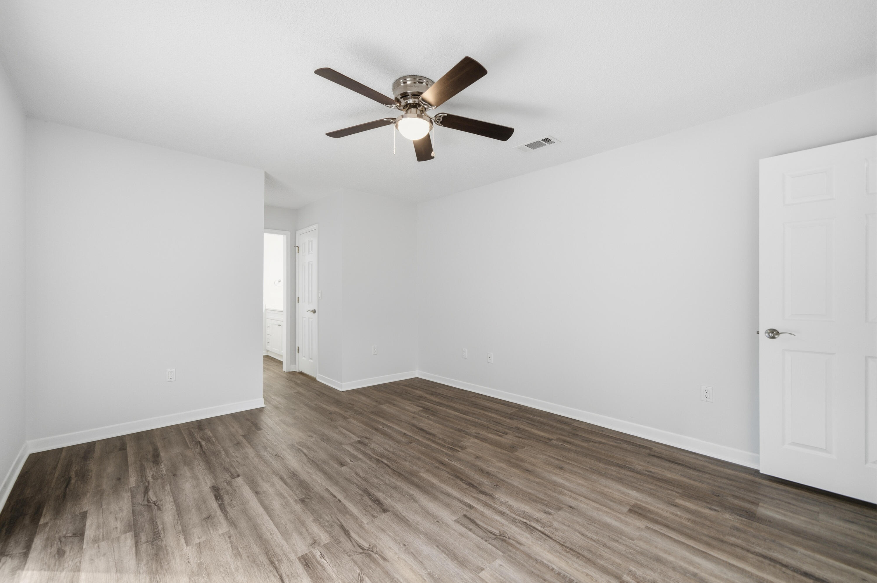 411 Ashley Drive Crestview, FL 32536 - Photo 24 of 44 a view of empty room with wooden floor